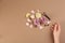 Woman with perfume. Fragrance composition, flowers and lemon on light brown background,  top view