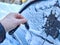 Woman Person Attempting to Unlock Car Covered in Snow by key on a Cold Winter Day. Finger holding a key near the frozen