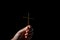 Woman person hand with jesus christ cross praying in dark background. Female christian worship to god in faith. Girl christian