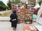 Woman perusing bookshelves on street market