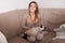 Woman petting her pet siamese beautiful cat at home