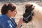 Woman Petting a Miniature Horse