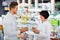 Woman pharmacist helping customers in drug store