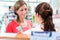 Woman in pharmacy being counseled by sales lady