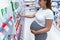 Woman pharmacy pregnant medicine. Young pregnancy girl customer in retail health drug store. Concept maternity