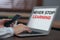 Woman with phone working on laptop at table, closeup. Never stop learning