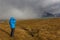 Woman photographer backpack hiker at Kungsleden trail admiring nature of Sarek in Sweden Lapland with mountains, rivers and lakes