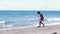 A woman photographer dropped the camera on the sand at the beach.