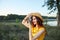 Woman photographer looking at camera with hat smile red lips summer fresh air