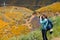Woman photographer takes photos at Walker Canyon in Lake Elsinore California during the poppy superbloom 2019