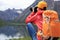 Woman photographer taking photo in mountains