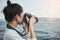 Woman photographer, taking pictures of landscape at sea