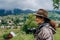 Woman photographer travels in the mountains in summer. Hiking in Europe. A woman photographs alpine landscapes.