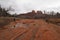 Woman photographing Cathedral Rock in Red Rock State Park outside of Sedona, Arizona on cloudy snowy winter day.