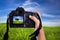 Woman photographing landscape with digital camera