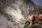 Woman photographing volcano crater