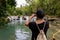 Woman photographing waterfalls.