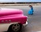 The woman photographs the ancient car on the Malecon street January 27, 2013 in Old Havana, Cuba