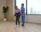 Woman physical therapist in blue uniform help an elderly to exercise and practice walking with Safety Transfer Belt. Atmosphere in