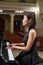 Woman pianist sits at the piano