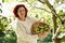 Woman picking apples in garden