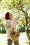 Woman picking apples off tree