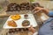 Woman picking chocolate muffin into her tray in bakery