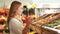 Woman picking out fruit in supermarket