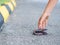 A Woman Picking Up Fallen Wallet On road side.