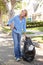 Woman Picking Up Litter In Suburban Street