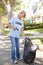 Woman Picking Up Litter In Suburban Street