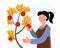 Woman picks apples from a tree in the garden. Gardening. Farming.