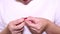 A woman picks at her nails. Young woman picking her nails. Female anxiously picking her nails