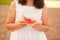 Woman with a piece of ripe watermelon in a hand in a picnic. Summer picnic. Vacation concept