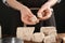 Woman with pieces of compressed yeast at wooden table, closeup