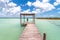 Woman on pier in Caribbean Bacalar lagoon, Mexico