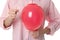 Woman piercing red balloon on white, closeup