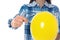 Woman piercing yellow balloon