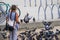 A woman pigeon whisperer playing with pigeons at the beach