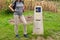 Woman pilgrim spending holidays walking the camino de Santiago in Spain. Yellow scallop shell, touristic symbol, column signing