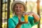 Woman with pill bottle smiling.