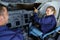 woman pilot pointing at cockpit during flight