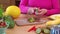 Woman in a Pink Blouse Chopping Juicy Green Kiwi