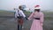 A woman in a pink dress and hat escorts the pilot to the war, slow motion shooting