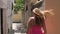 Woman In A Pink Dress Walks Down The Stairs Of Ancient Stone Town, Back View