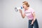 woman in pink feminist t-shirt yelling at megaphone