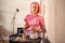 Woman with pink hair stirring in a bowl for the matcha tea