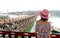 Woman in Pink Hat Admiring the Mon Bridge, stunning Landmark of Sangkhlaburi District, Thailand