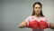 Woman with pink ribbon in boxing gloves, fighting against breast cancer concept