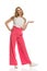 Woman In Pink Wide Legs Trousers Is Standing, Gesturing, Talking And Looking Away